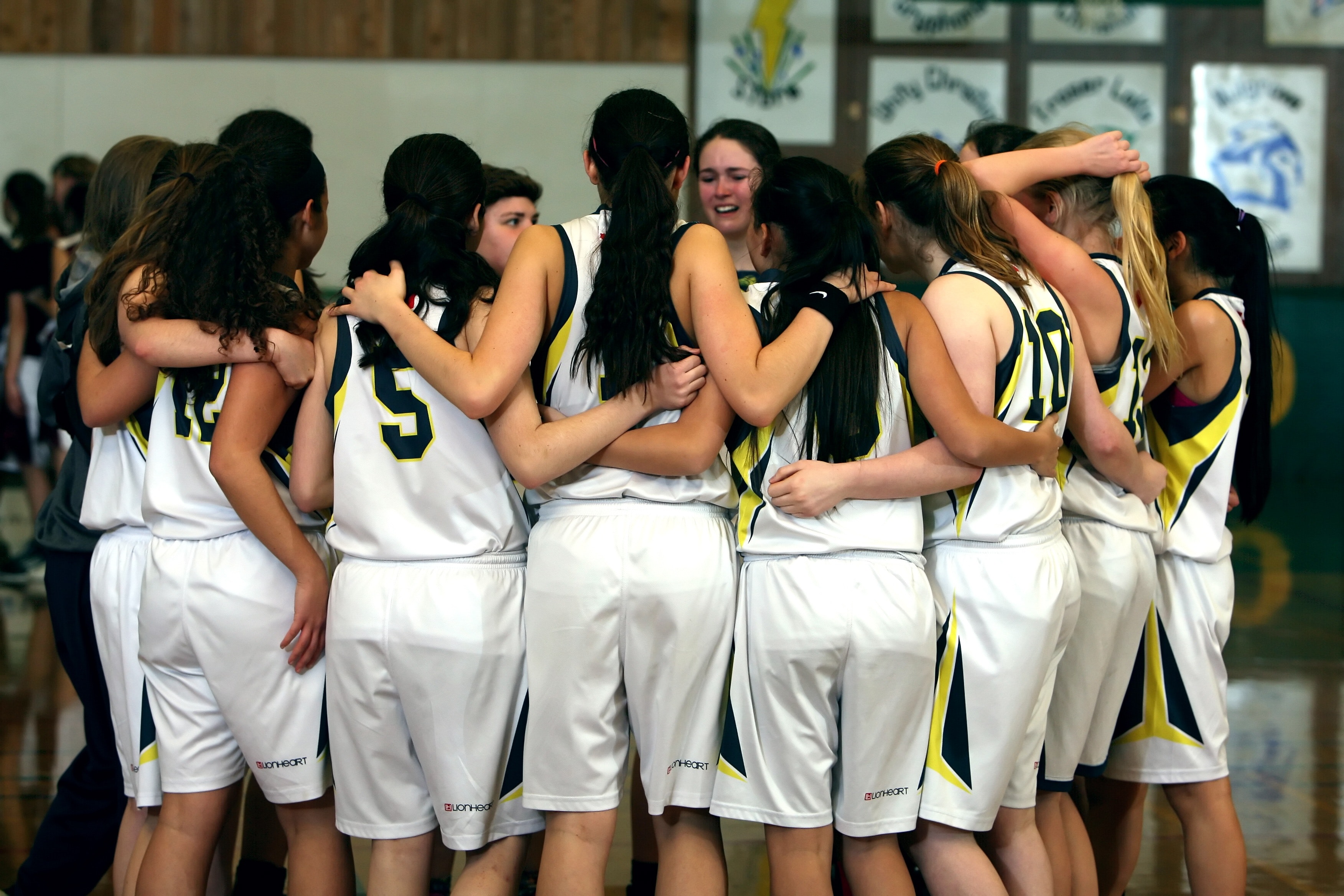female sports team in huddle